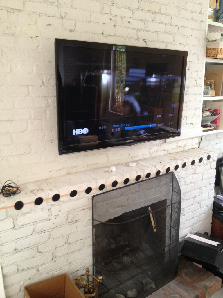 TV installation over a brick fireplace
