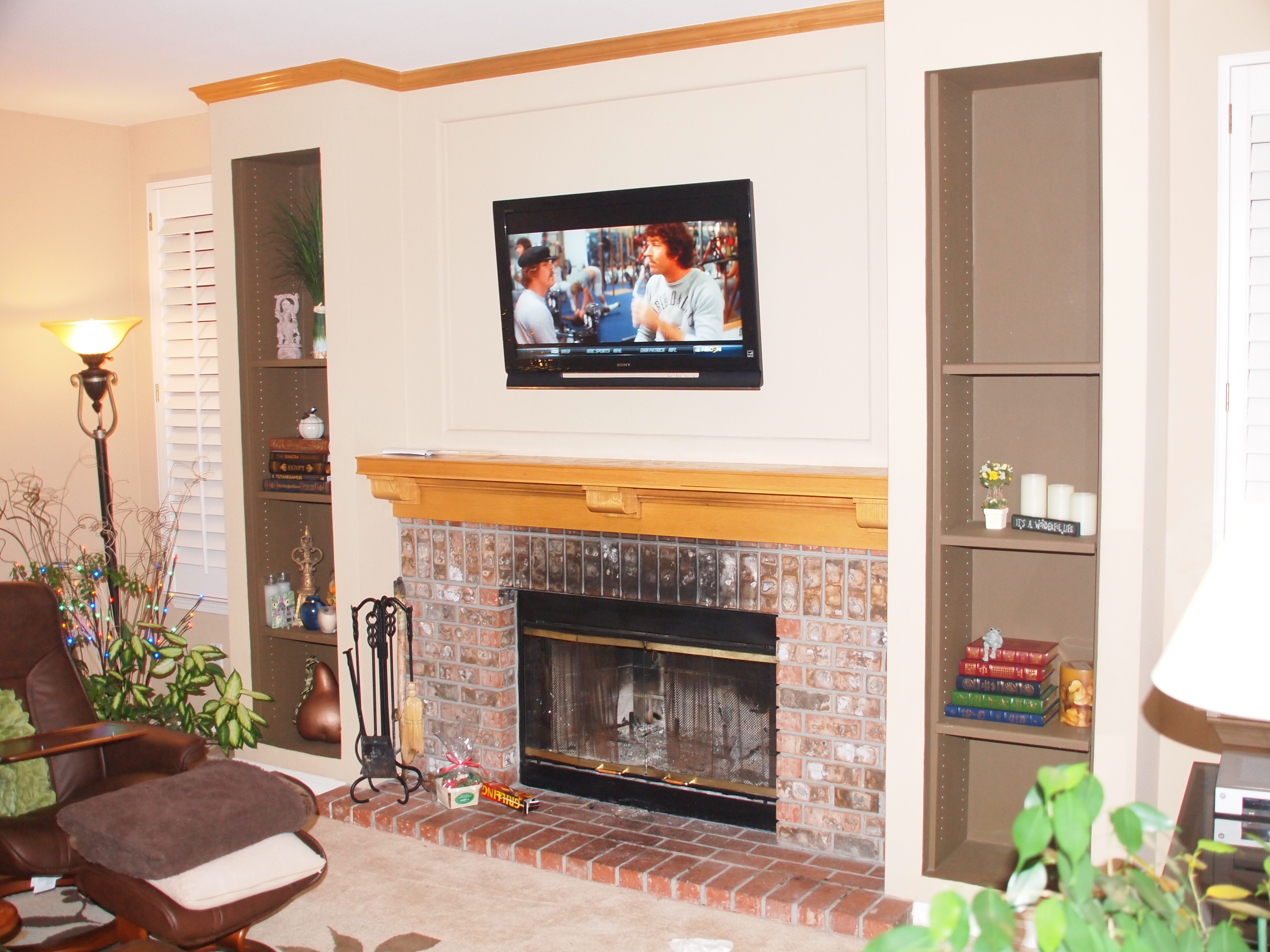 TV Mounting over a fireplace with wires concealed in the wall