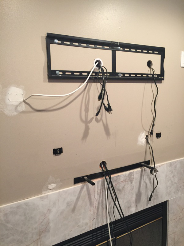 TV Mounting over a fireplace with wires concealed in the wall Nextdaytechs Onsite Technical